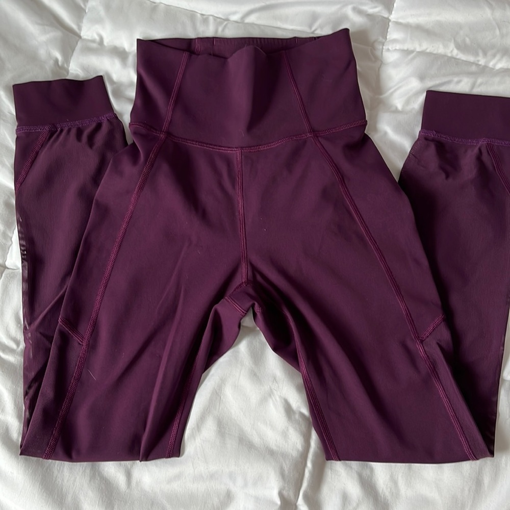 Lululemon maroon leggings with mesh detail on the legs